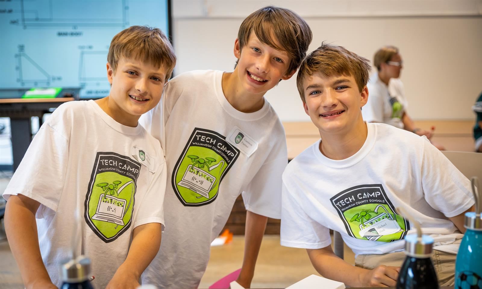 Three boys smile